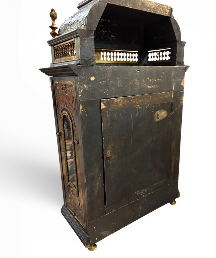 19th-century religious pendule in Boulle marquetry. Boulle marquetry cabinet by Gérard of Liège, from the Napoleonic period, in the Louis XIV Regency style. Beautiful cabinet design; the front features a door flanked by two Boulle pilasters 