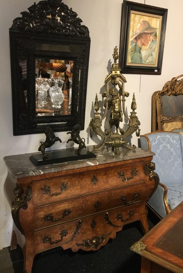 A Chest Of Drawers With Large Bronze Decorations And Marble Top