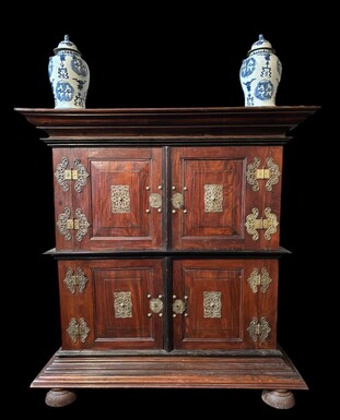 Colonial 4-door cabinet with 18th century bronze fittings Special piece of furniture from the Dutch Indies in tropical wood and ebony with 4 doors and beautiful bronze fittings. It stands on large carved feet. The cabinet can be dismantled.