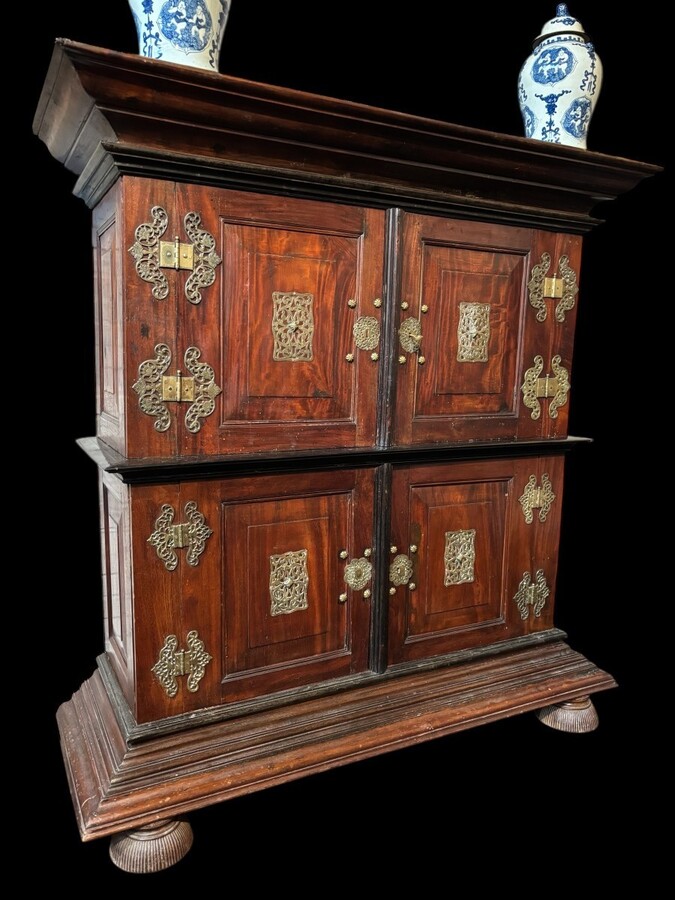 Colonial 4-door cabinet with 18th century bronze fittings Special piece of furniture from the Dutch Indies in tropical wood and ebony with 4 doors and beautiful bronze fittings. It stands on large carved feet. The cabinet can be dismantled.
