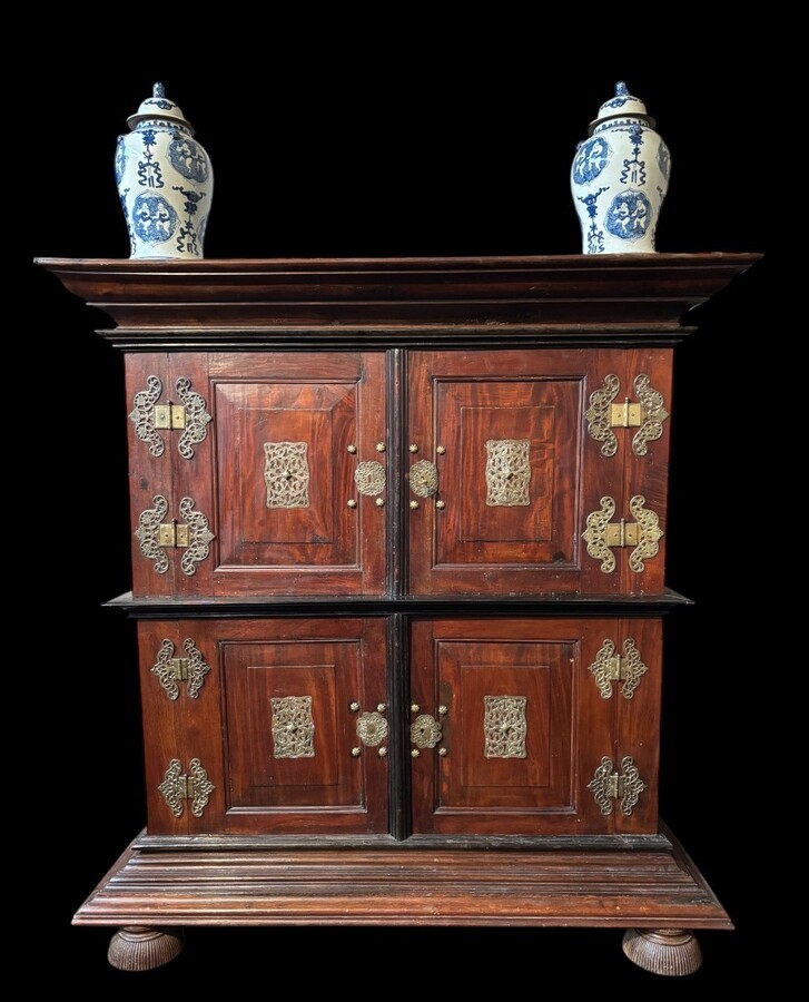 Colonial 4-door cabinet with 18th century bronze fittings Special piece of furniture from the Dutch Indies in tropical wood and ebony with 4 doors and beautiful bronze fittings. It stands on large carved feet. The cabinet can be dismantled.