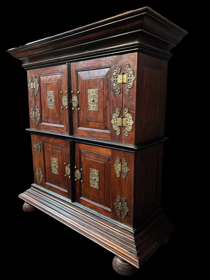Colonial 4-door cabinet with 18th century bronze fittings Special piece of furniture from the Dutch Indies in tropical wood and ebony with 4 doors and beautiful bronze fittings. It stands on large carved feet. The cabinet can be dismantled.