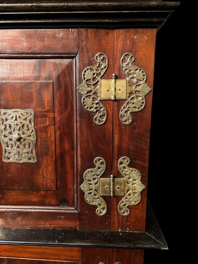 Colonial 4-door cabinet with 18th century bronze fittings Special piece of furniture from the Dutch Indies in tropical wood and ebony with 4 doors and beautiful bronze fittings. It stands on large carved feet. The cabinet can be dismantled.