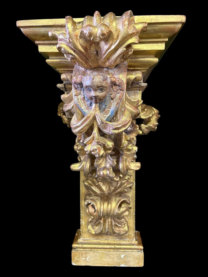 Pair of 17th-century Italian Baroque consoles. Decorative consoles carved in wood, gilded/polychrome, with garlands, fruit, angel heads and decorative ornaments. Ideal for creating a beautiful wall console. Both are in good condition, with normal signs of