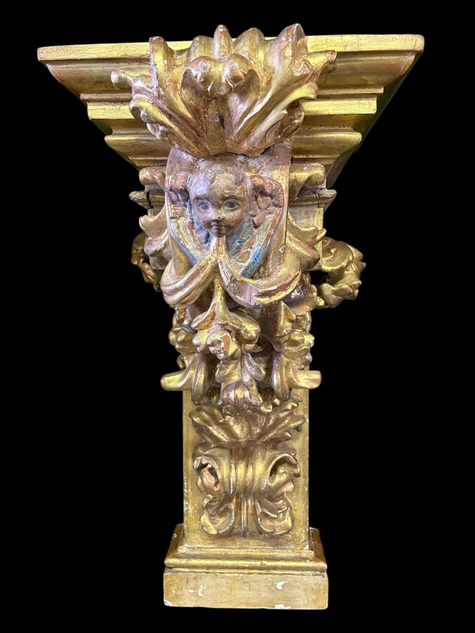 Pair of 17th-century Italian Baroque consoles. Decorative consoles carved in wood, gilded/polychrome, with garlands, fruit, angel heads and decorative ornaments. Ideal for creating a beautiful wall console. Both are in good condition, with normal signs of