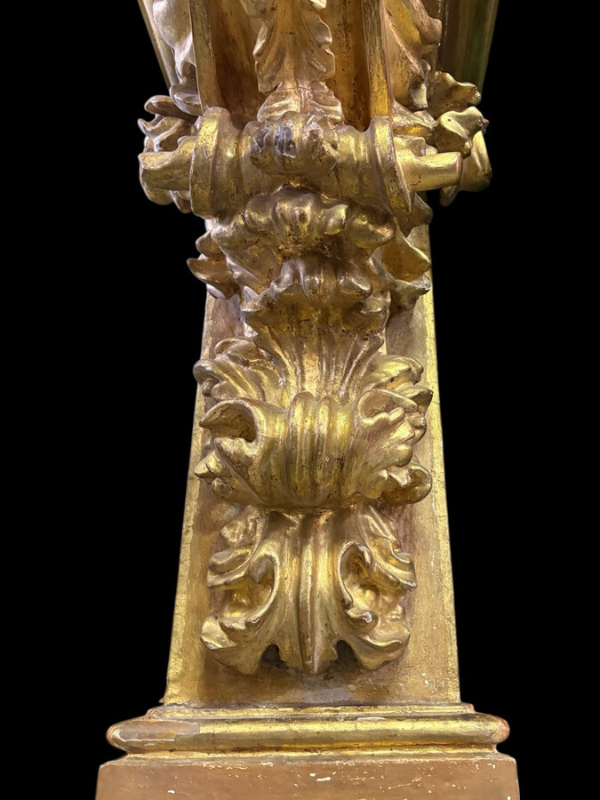 Pair of 17th-century Italian Baroque consoles. Decorative consoles carved in wood, gilded/polychrome, with garlands, fruit, angel heads and decorative ornaments. Ideal for creating a beautiful wall console. Both are in good condition, with normal signs of