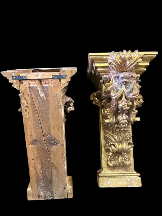 Pair of 17th-century Italian Baroque consoles. Decorative consoles carved in wood, gilded/polychrome, with garlands, fruit, angel heads and decorative ornaments. Ideal for creating a beautiful wall console. Both are in good condition, with normal signs of