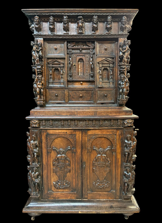 16th-century Italian Renaissance walnut cabinet Magnificent two-part cabinet with numerous doors and drawers, adorned with superb carvings and decorations. The upper section rests on its original base. Exceptional cabinet