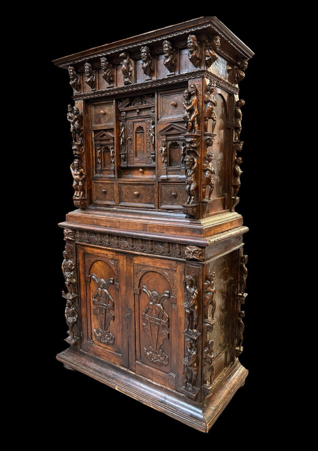 16th-century Italian Renaissance walnut cabinet Magnificent two-part cabinet with numerous doors and drawers, adorned with superb carvings and decorations. The upper section rests on its original base. Exceptional cabinet