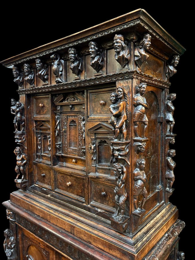 16th-century Italian Renaissance walnut cabinet Magnificent two-part cabinet with numerous doors and drawers, adorned with superb carvings and decorations. The upper section rests on its original base. Exceptional cabinet