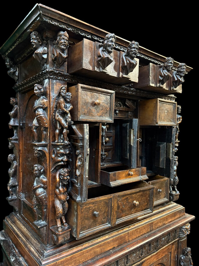 16th-century Italian Renaissance walnut cabinet Magnificent two-part cabinet with numerous doors and drawers, adorned with superb carvings and decorations. The upper section rests on its original base. Exceptional cabinet