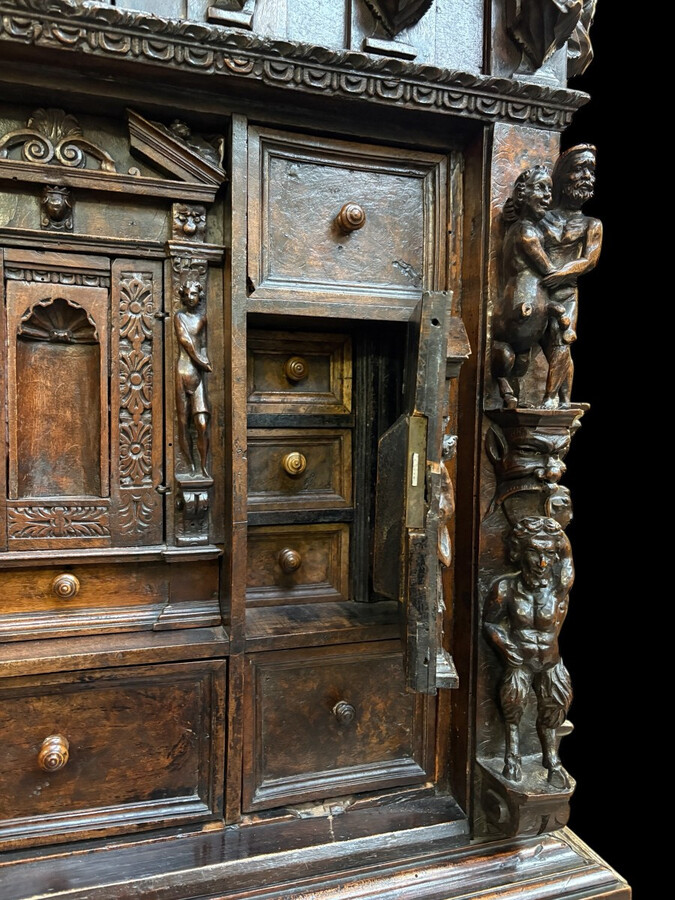 16th-century Italian Renaissance walnut cabinet Magnificent two-part cabinet with numerous doors and drawers, adorned with superb carvings and decorations. The upper section rests on its original base. Exceptional cabinet