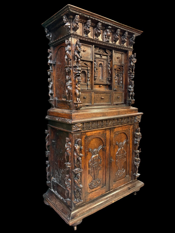 16th-century Italian Renaissance walnut cabinet Magnificent two-part cabinet with numerous doors and drawers, adorned with superb carvings and decorations. The upper section rests on its original base. Exceptional cabinet