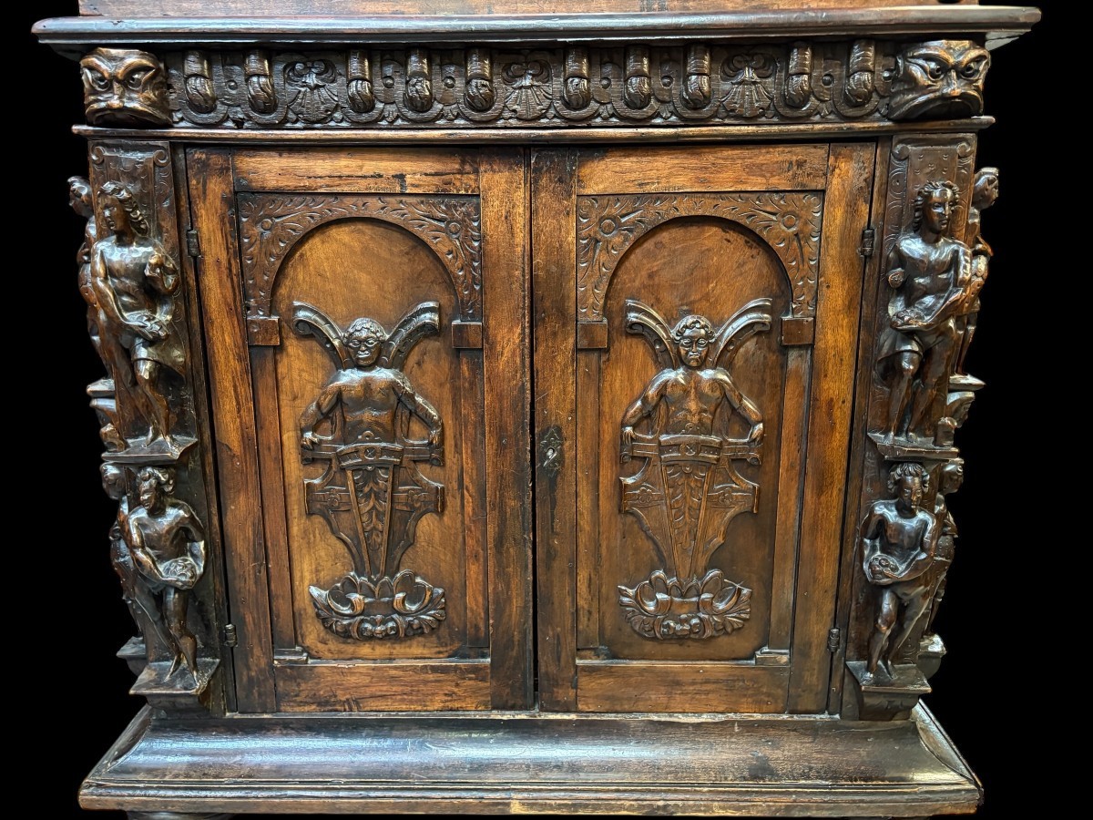 16th-century Italian Renaissance walnut cabinet Magnificent two-part cabinet with numerous doors and drawers, adorned with superb carvings and decorations. The upper section rests on its original base. Exceptional cabinet