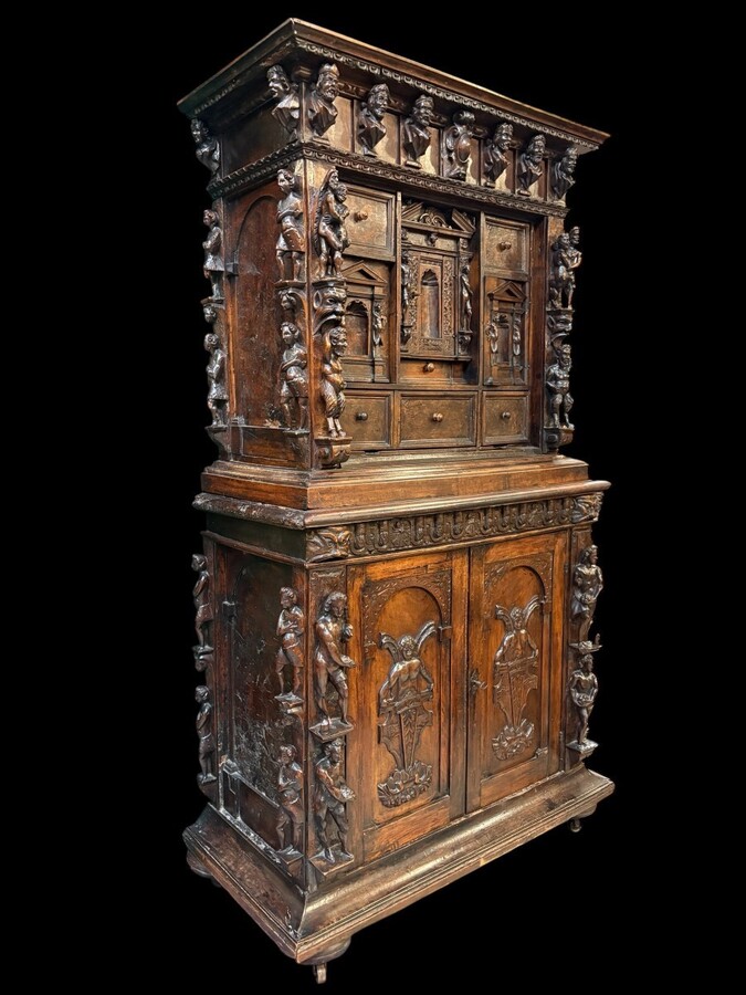 16th-century Italian Renaissance walnut cabinet Magnificent two-part cabinet with numerous doors and drawers, adorned with superb carvings and decorations. The upper section rests on its original base. Exceptional cabinet