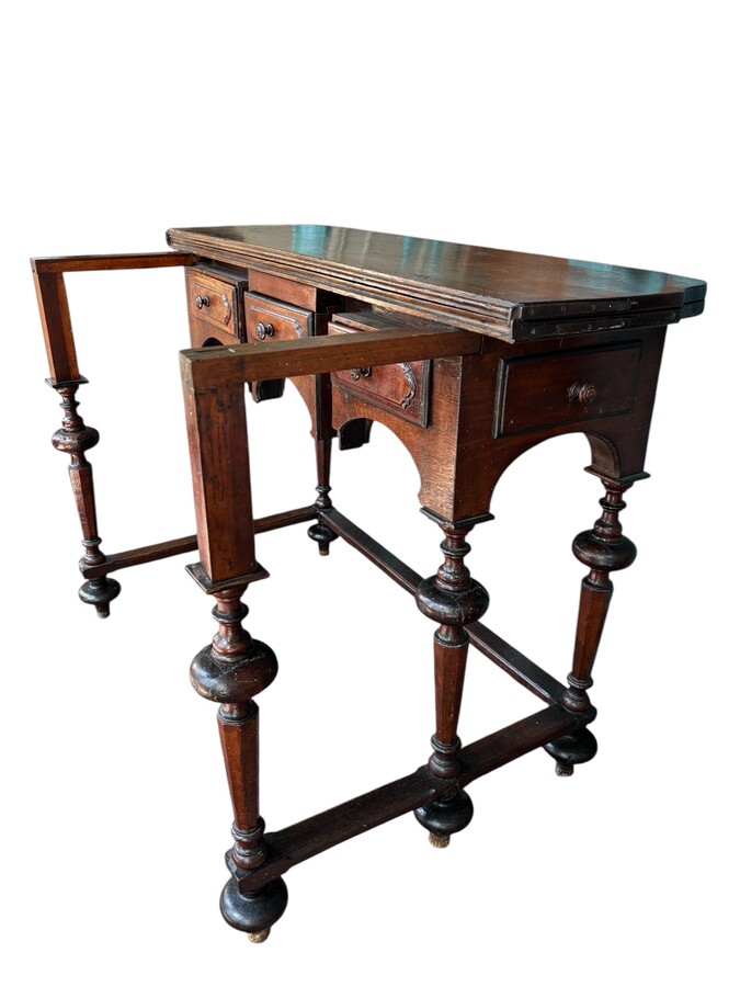 17th century walnut folding table. Elegant Louis XIV walnut and oak folding/writing table with folding system, 3 small drawers and folding top. Beautiful table in used condition with some minor defects. 