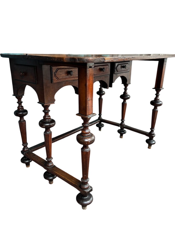 17th century walnut folding table. Elegant Louis XIV walnut and oak folding/writing table with folding system, 3 small drawers and folding top. Beautiful table in used condition with some minor defects. 