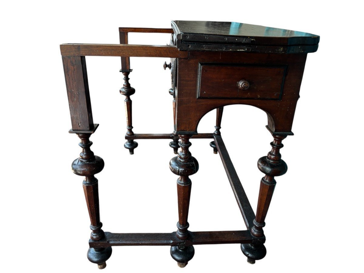 17th century walnut folding table. Elegant Louis XIV walnut and oak folding/writing table with folding system, 3 small drawers and folding top. Beautiful table in used condition with some minor defects.