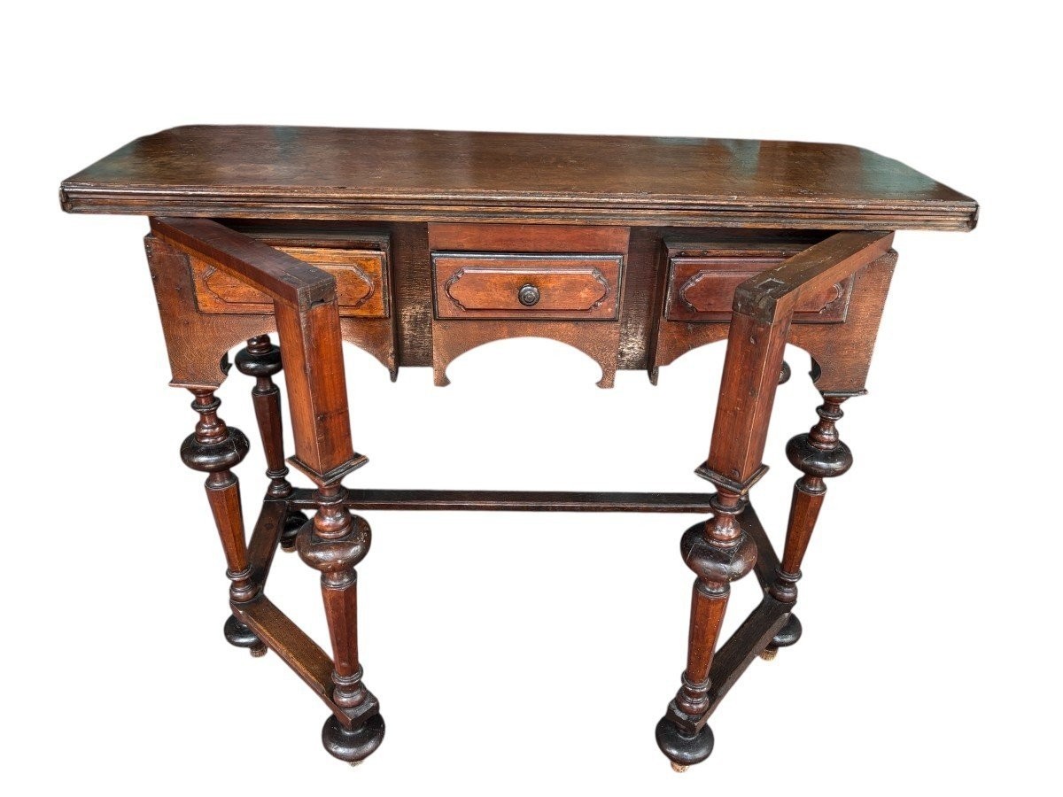 17th century walnut folding table. Elegant Louis XIV walnut and oak folding/writing table with folding system, 3 small drawers and folding top. Beautiful table in used condition with some minor defects.