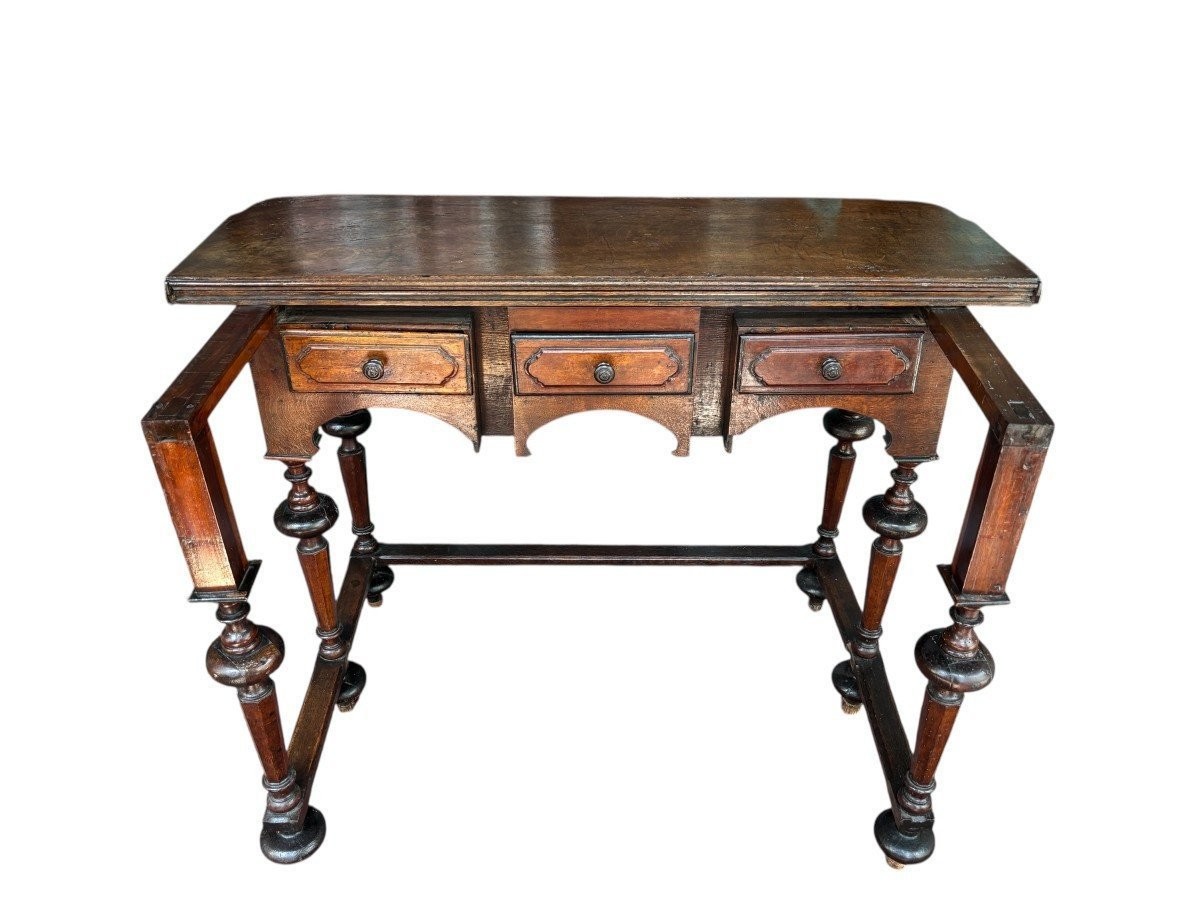 17th century walnut folding table. Elegant Louis XIV walnut and oak folding/writing table with folding system, 3 small drawers and folding top. Beautiful table in used condition with some minor defects.