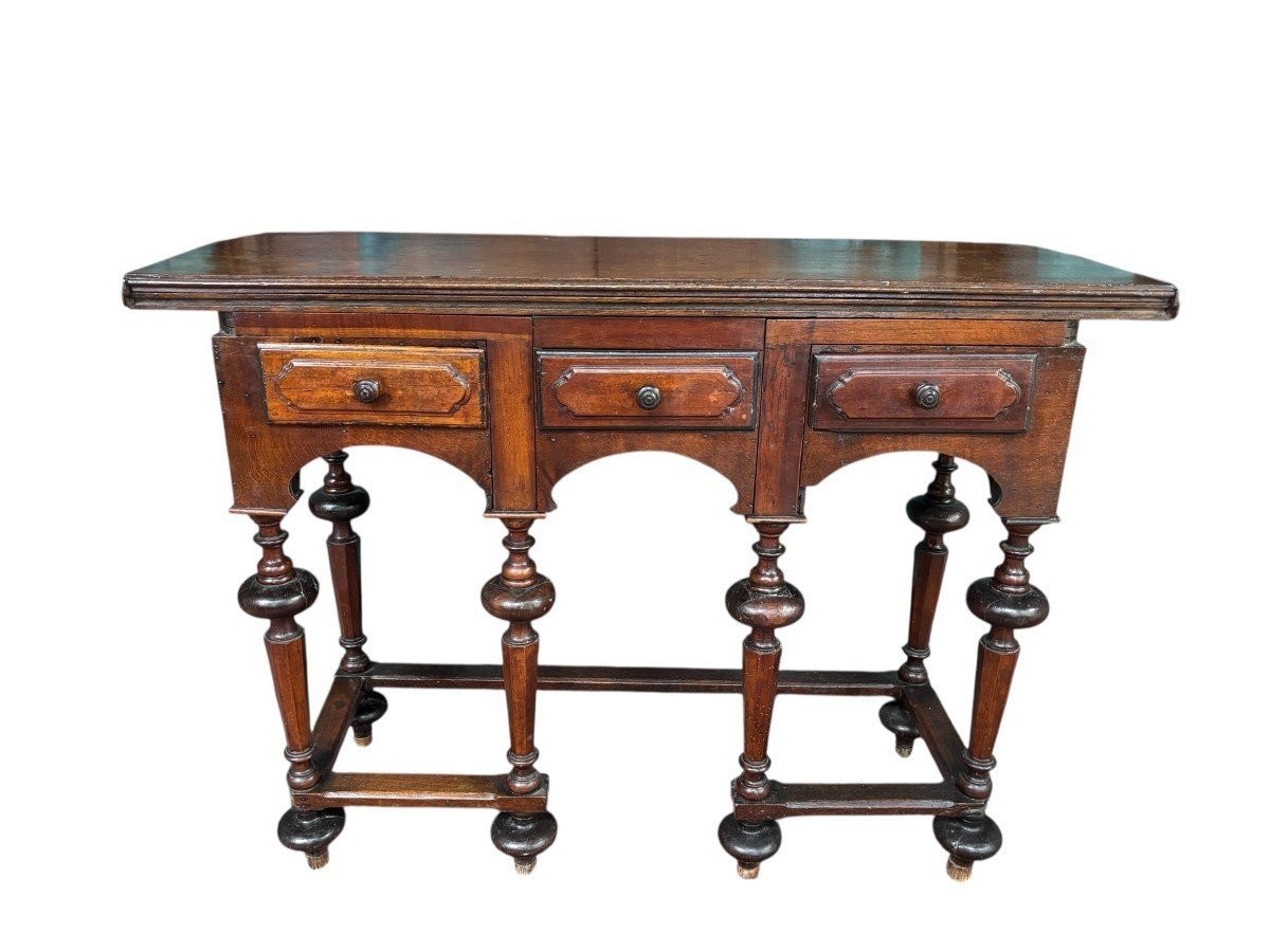 17th century walnut folding table. Elegant Louis XIV walnut and oak folding/writing table with folding system, 3 small drawers and folding top. Beautiful table in used condition with some minor defects.