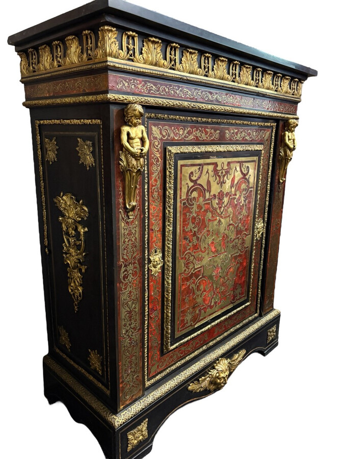 19th century Boulle marquetry sideboard in blackened pear wood inlaid with copper filigree, red tortoiseshell and copper veneer. (restoration required). Chiselled and gilded bronze decorations with acanthus leaves, clasps and rosettes. Black marble top.