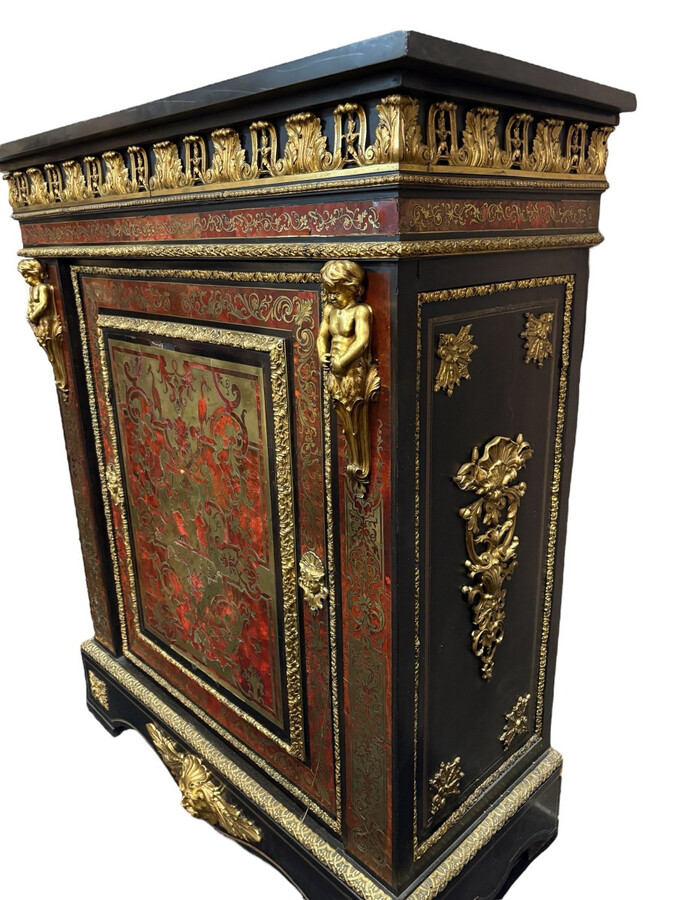 19th century Boulle marquetry sideboard in blackened pear wood inlaid with copper filigree, red tortoiseshell and copper veneer. (restoration required). Chiselled and gilded bronze decorations with acanthus leaves, clasps and rosettes. Black marble top.