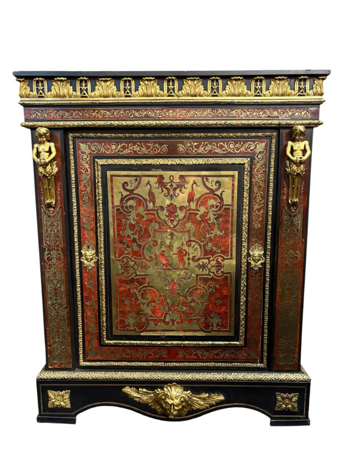 19th century Boulle marquetry sideboard in blackened pear wood inlaid with copper filigree, red tortoiseshell and copper veneer. (restoration required). Chiselled and gilded bronze decorations with acanthus leaves, clasps and rosettes. Black marble top.