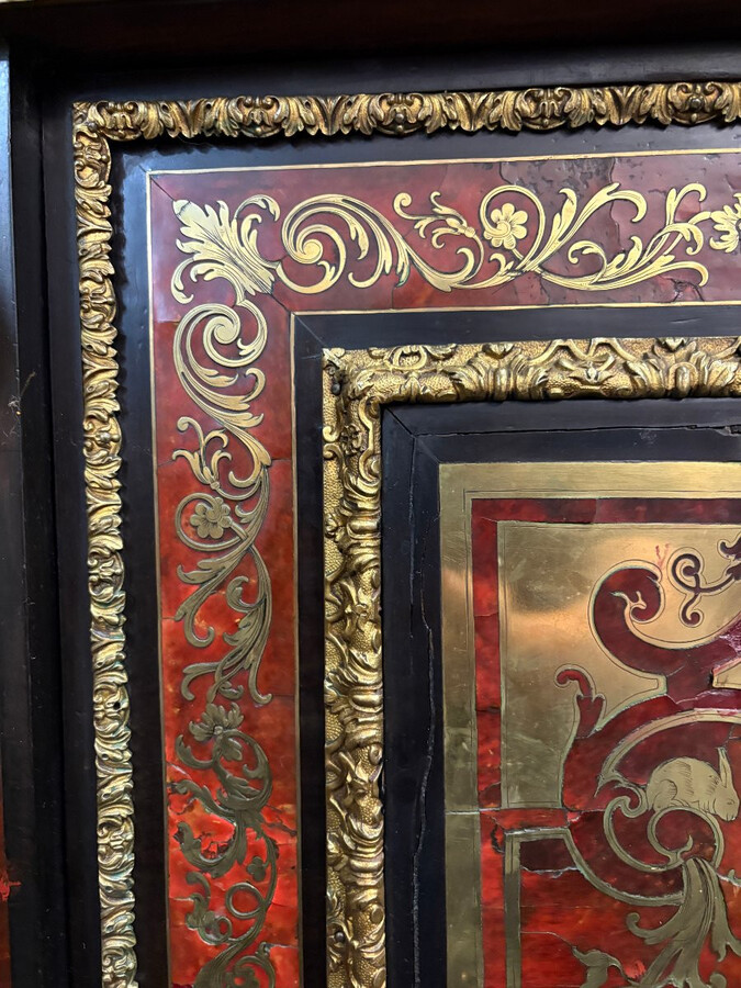 19th century Boulle marquetry sideboard in blackened pear wood inlaid with copper filigree, red tortoiseshell and copper veneer. (restoration required). Chiselled and gilded bronze decorations with acanthus leaves, clasps and rosettes. Black marble top.