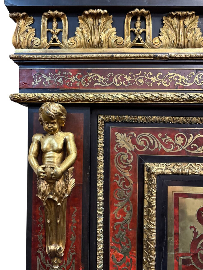 19th century Boulle marquetry sideboard in blackened pear wood inlaid with copper filigree, red tortoiseshell and copper veneer. (restoration required). Chiselled and gilded bronze decorations with acanthus leaves, clasps and rosettes. Black marble top.