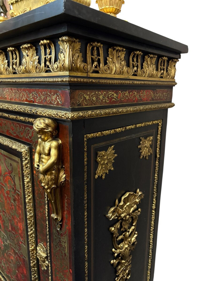 19th century Boulle marquetry sideboard in blackened pear wood inlaid with copper filigree, red tortoiseshell and copper veneer. (restoration required). Chiselled and gilded bronze decorations with acanthus leaves, clasps and rosettes. Black marble top.