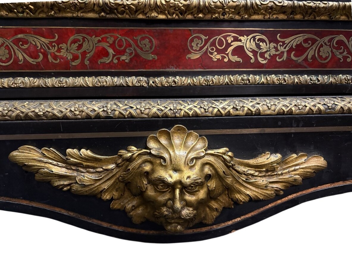 19th century Boulle marquetry sideboard in blackened pear wood inlaid with copper filigree, red tortoiseshell and copper veneer. (restoration required). Chiselled and gilded bronze decorations with acanthus leaves, clasps and rosettes. Black marble top.