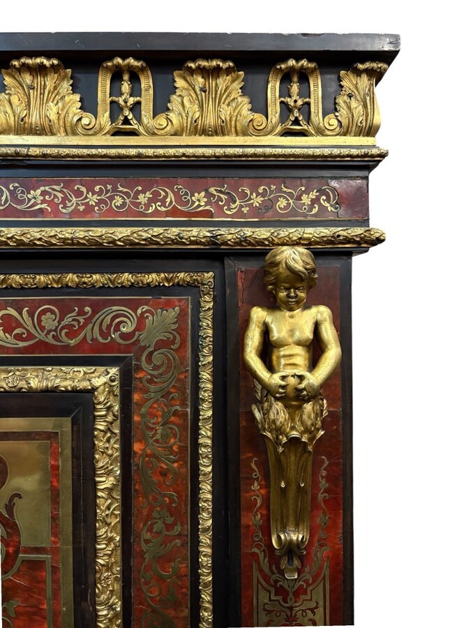 19th century Boulle marquetry sideboard in blackened pear wood inlaid with copper filigree, red tortoiseshell and copper veneer. (restoration required). Chiselled and gilded bronze decorations with acanthus leaves, clasps and rosettes. Black marble top.