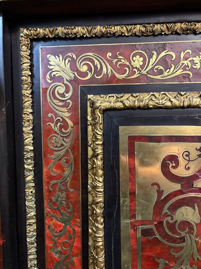 19th century Boulle marquetry sideboard in blackened pear wood inlaid with copper filigree, red tortoiseshell and copper veneer. (restoration required). Chiselled and gilded bronze decorations with acanthus leaves, clasps and rosettes. Black marble top.
