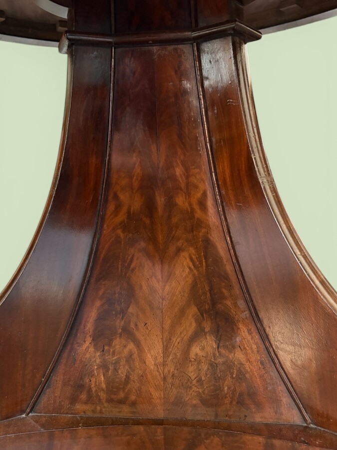  19th-century Charles X-style mahogany pedestal table. Table, featuring three elegant curved legs adorned with ram’s heads. The top is edged with a solid mahogany rim. In good condition, with slight signs of we