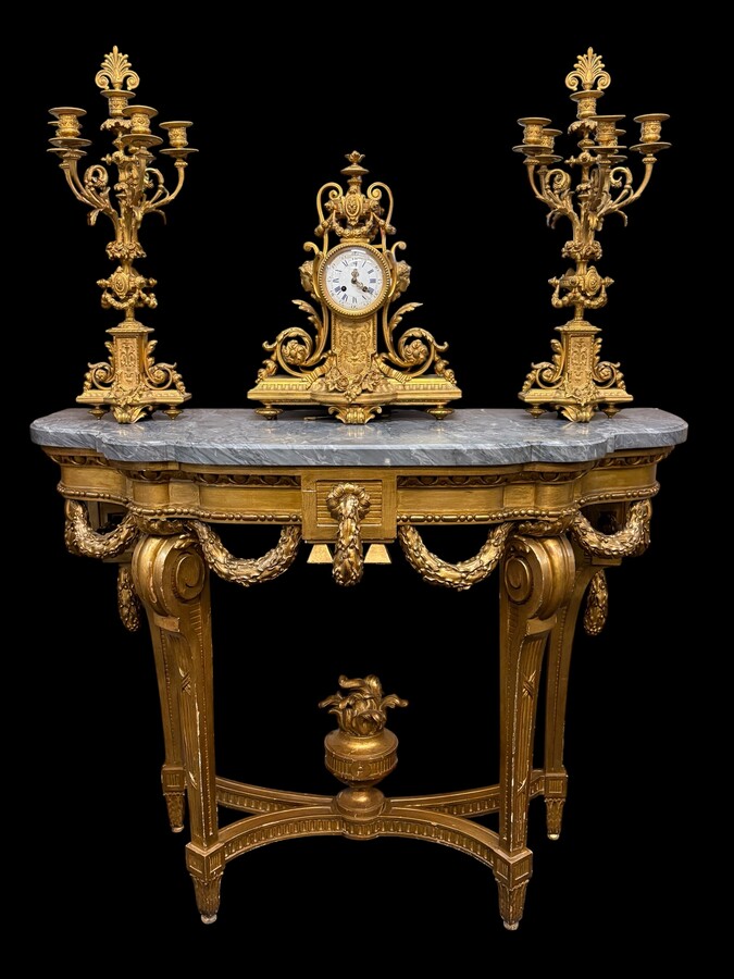  19th-century Louis XVI-style console table in gilded wood. The console features four legs decorated with garlands and a large vase at the base, topped with a superb 3 cm thick grey marble top. The console and marble top are in good condition, w