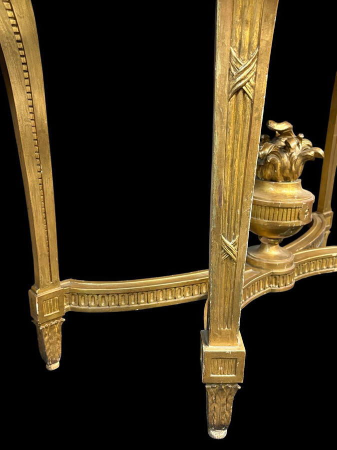 19th-century Louis XVI-style console table in gilded wood. The console features four legs decorated with garlands and a large vase at the base, topped with a superb 3 cm thick grey marble top. The console and marble top are in good condition