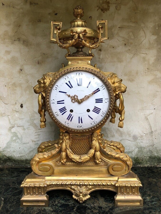 A Large Gilt Bronze LXVI Style Mantelpiece Paris, 19th Century. The Clock And The Candelabras Are Gilded With Matt And Bright Gold. Clock Signed By G.Philippe, Palais Royal 66 & 67 In Paris. Dimensions Clock: 68 Cm High, 42 Cm Wide And 24 Cm Deep.