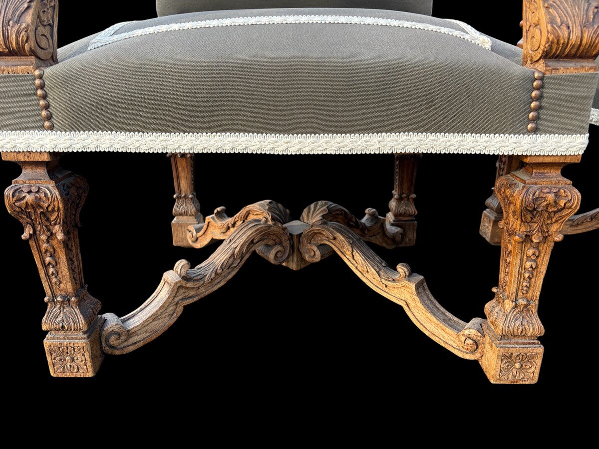 A pair of large 19th-century Regency-style oak armchairs. Decorative oak armchairs, upholstered in taupe fabric with a lace ribbon border. Dimensions: Height: 121 cm Width: 67 cm Depth: 70 cm