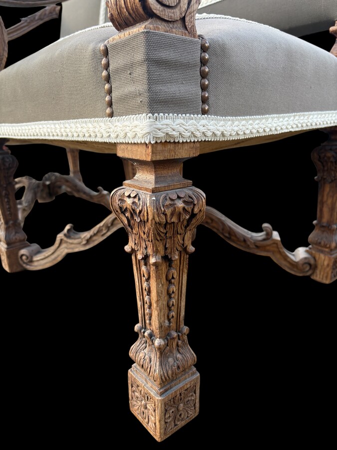 A pair of large 19th-century Regency-style oak armchairs. Decorative oak armchairs, upholstered in taupe fabric with a lace ribbon border. Dimensions: Height: 121 cm Width: 67 cm Depth: 70 cm