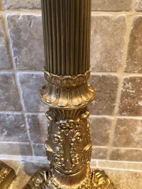 A pair of large gilded bronze candlesticks/lamp bases Charles X , some fish tails(3) are missing. Dimensions : 54 cm high and 23 cm wide.