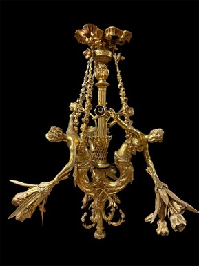 A pair of large gilded bronze chandeliers depicting three mythological women , 20thC. Nice chandeliers with 15 light points, featuring three mythological women holding a bouquet of flowers; at the top, a large Louis XVI-style bow 