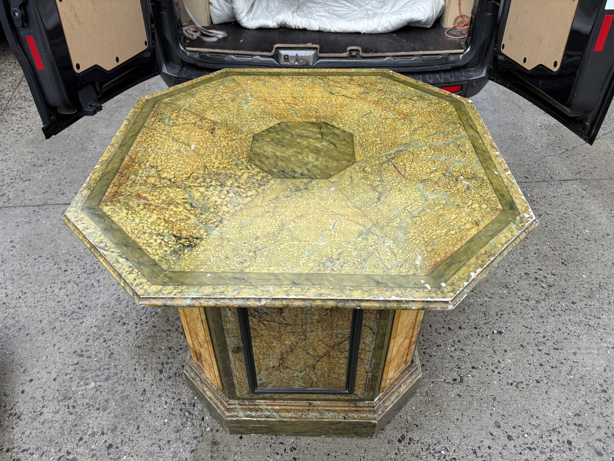 A special table painted to resemble marble 20th century. A decorative piece that can be used as a table, a pedestal or a piece of furniture. It features a triangular wooden top resting on a wooden base fitted with four panelled doors