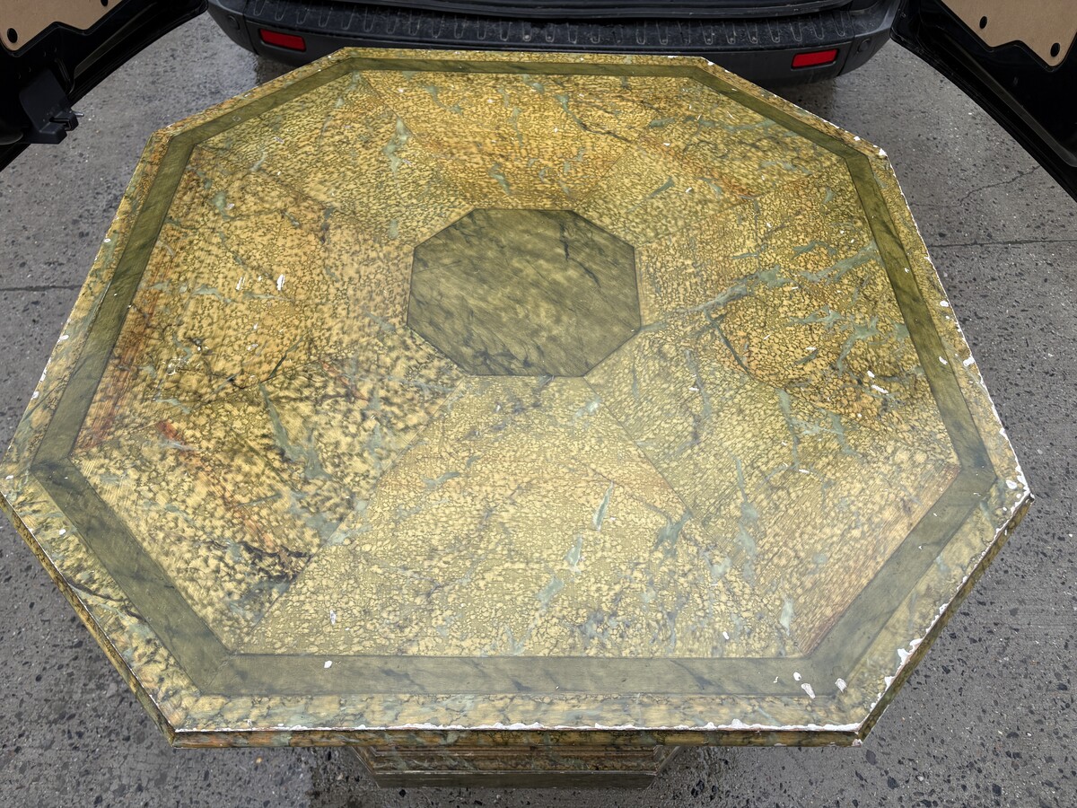 A special table painted to resemble marble 20th century. A decorative piece that can be used as a table, a pedestal or a piece of furniture. It features a triangular wooden top resting on a wooden base fitted with four panelled doors