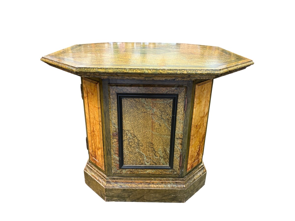 A special table painted to resemble marble 20th century. A decorative piece that can be used as a table, a pedestal or a piece of furniture. It features a triangular wooden top resting on a wooden base fitted with four panelled doors