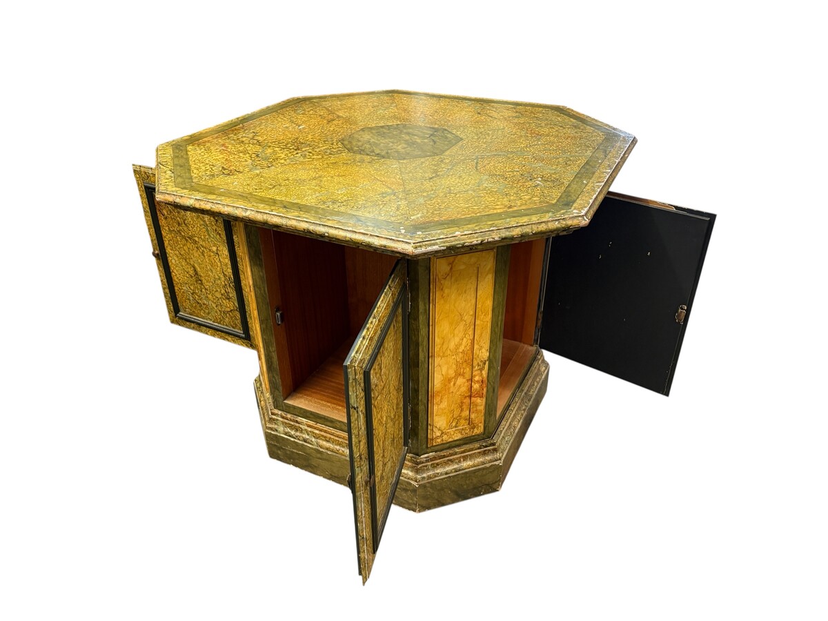A special table painted to resemble marble 20th century. A decorative piece that can be used as a table, a pedestal or a piece of furniture. It features a triangular wooden top resting on a wooden base fitted with four panelled doors