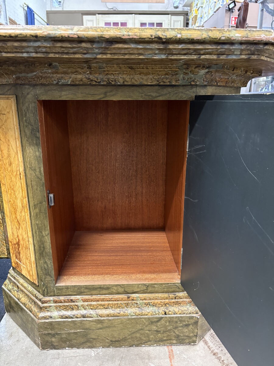 A special table painted to resemble marble 20th century. A decorative piece that can be used as a table, a pedestal or a piece of furniture. It features a triangular wooden top resting on a wooden base fitted with four panelled doors