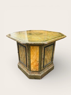 A special table painted to resemble marble 20th century. A decorative piece that can be used as a table, a pedestal or a piece of furniture. It features a triangular wooden top resting on a wooden base fitted with four panelled doors
