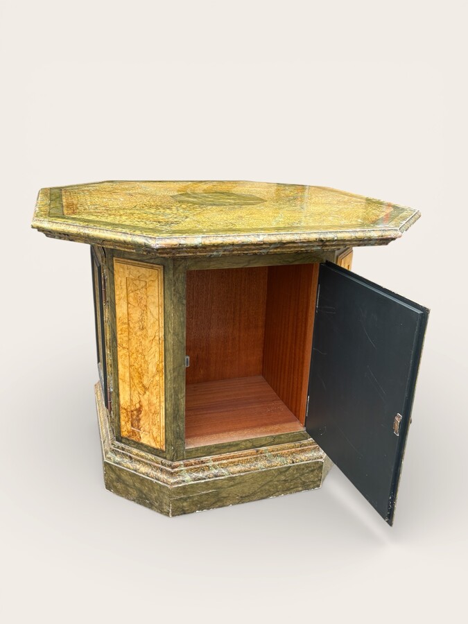 A special table painted to resemble marble 20th century. A decorative piece that can be used as a table, a pedestal or a piece of furniture. It features a triangular wooden top resting on a wooden base fitted with four panelled doors