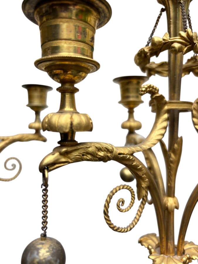 An elegant pair of candelabras in finely chased, gilded and patinated bronze. The shaft is adorned with an antique draped female figure, resting on a green marble base. In the Louis XVI style, these pieces date from the early 19th century. 